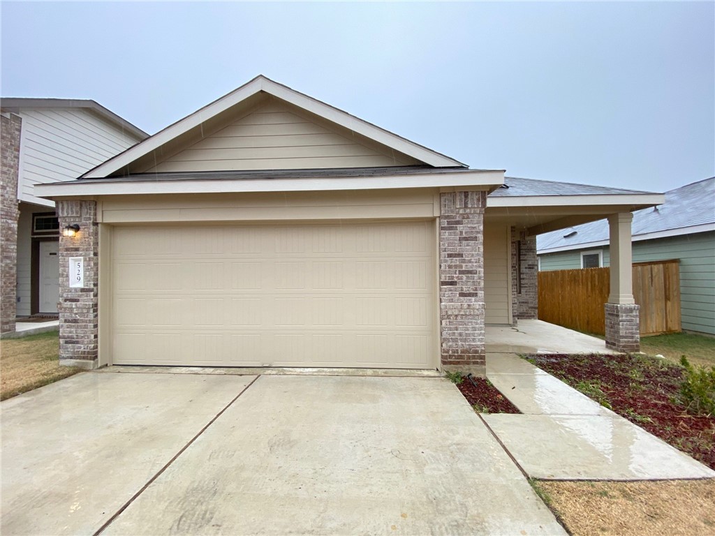 a front view of a house with garage