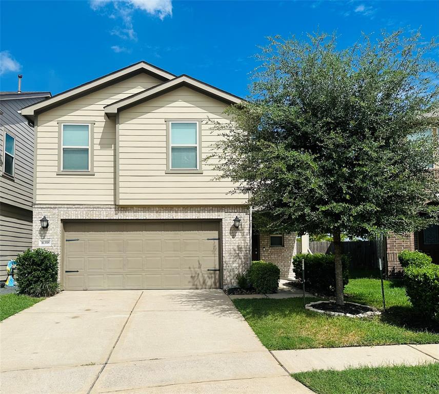 a front view of a house with a yard and garage