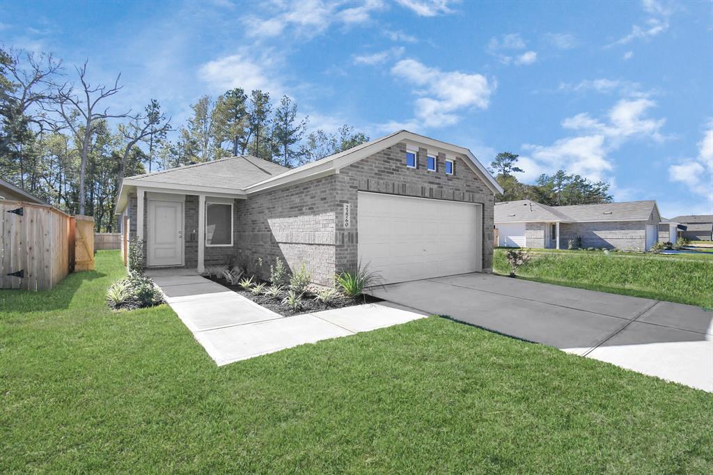 a front view of a house with a yard and garage