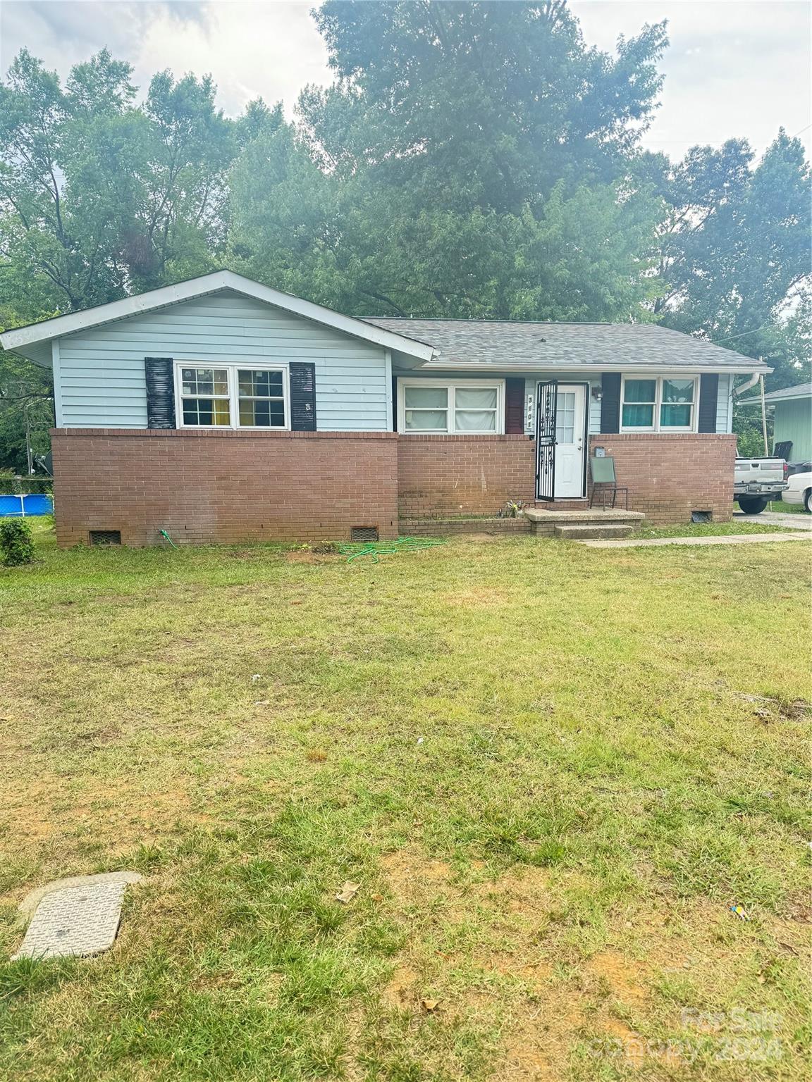 a front view of a house with a garden