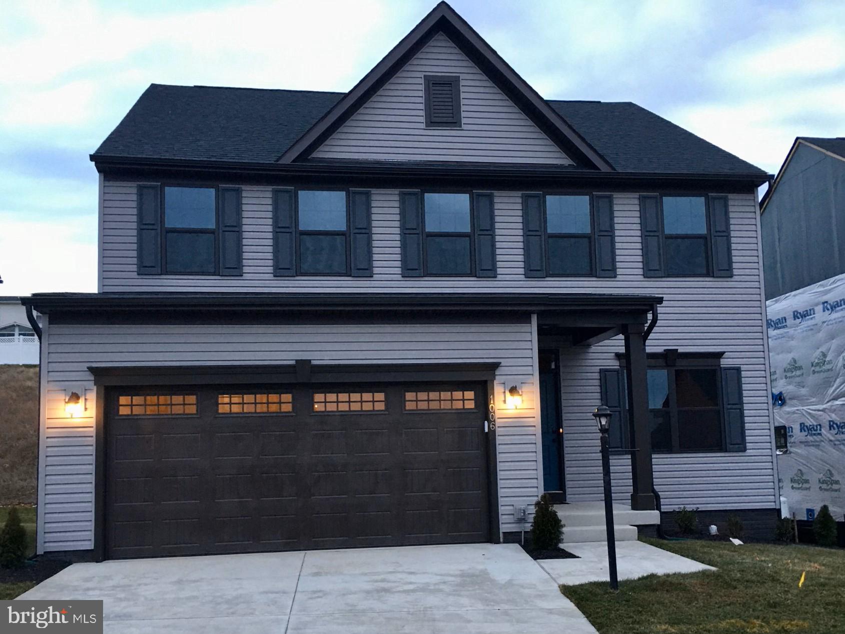 a front view of a house with garage