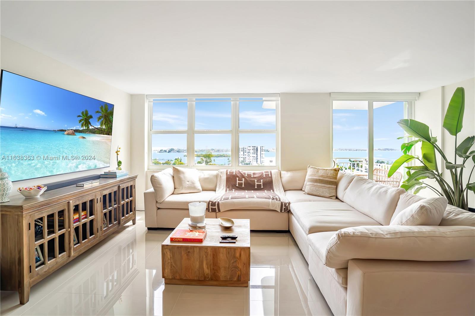 a living room with furniture a flat screen tv and a couch