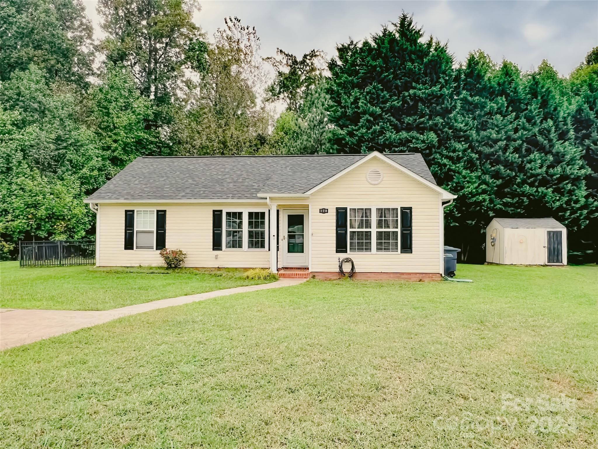 a front of a house with a garden and yard