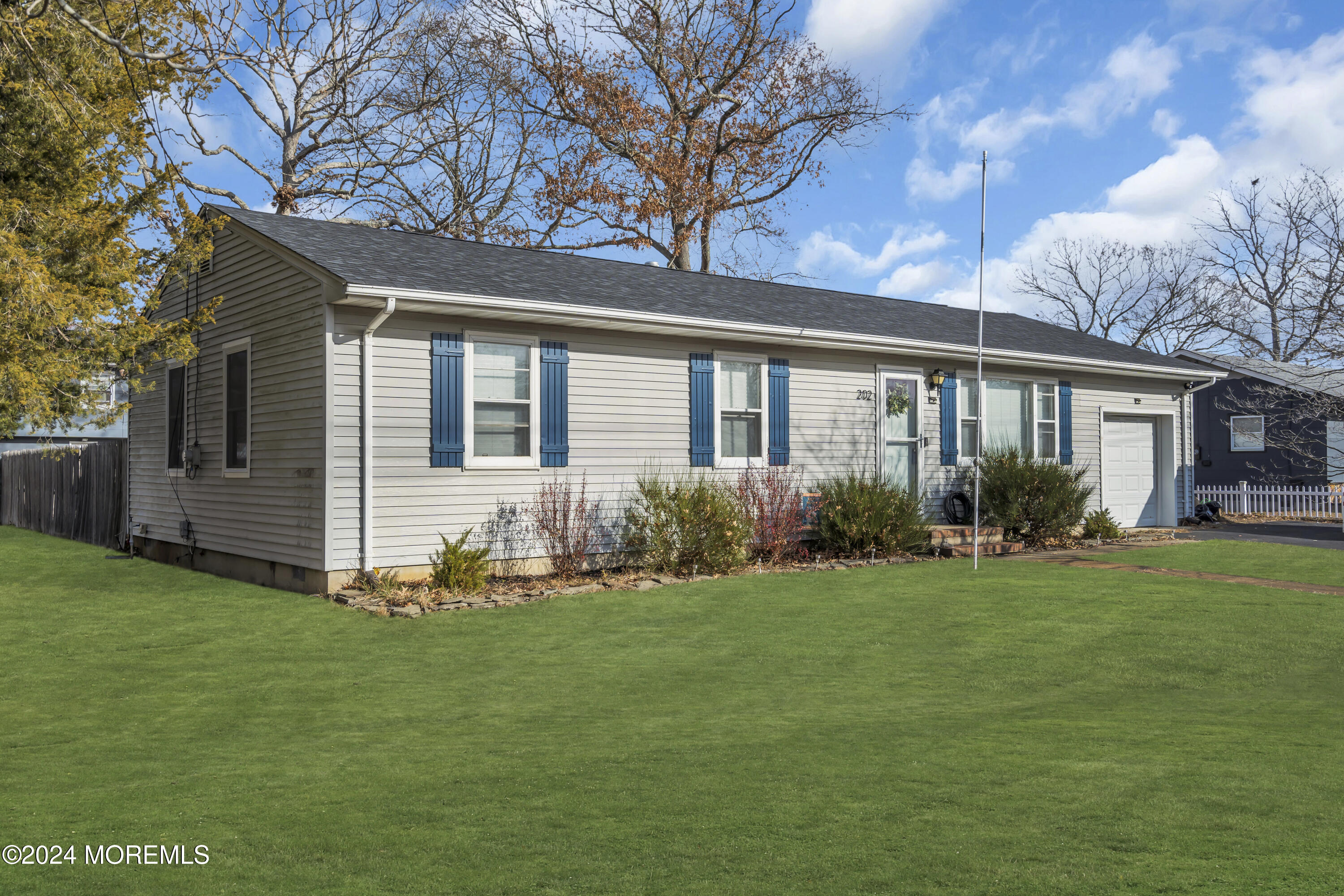 a front view of house with yard outdoor seating and green space