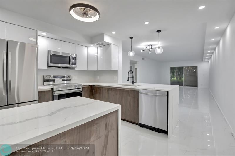 a kitchen with cabinets and stainless steel appliances