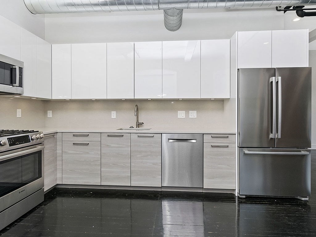 a kitchen with cabinets and stainless steel appliances