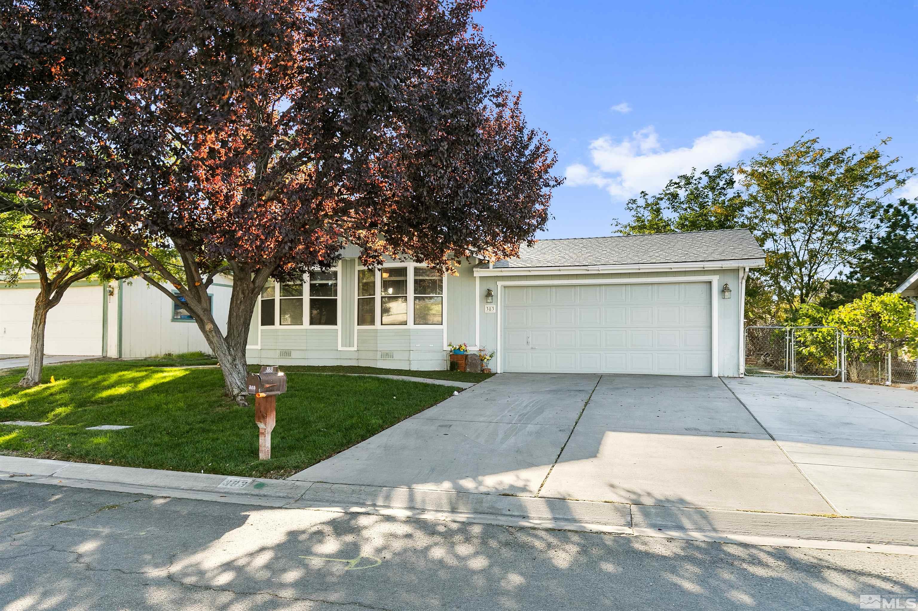 front view of a house with a yard and trees