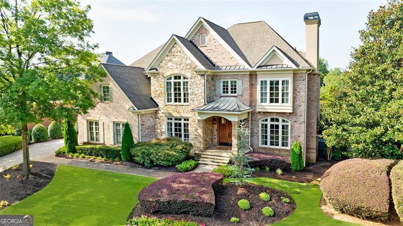 a front view of a house with a garden