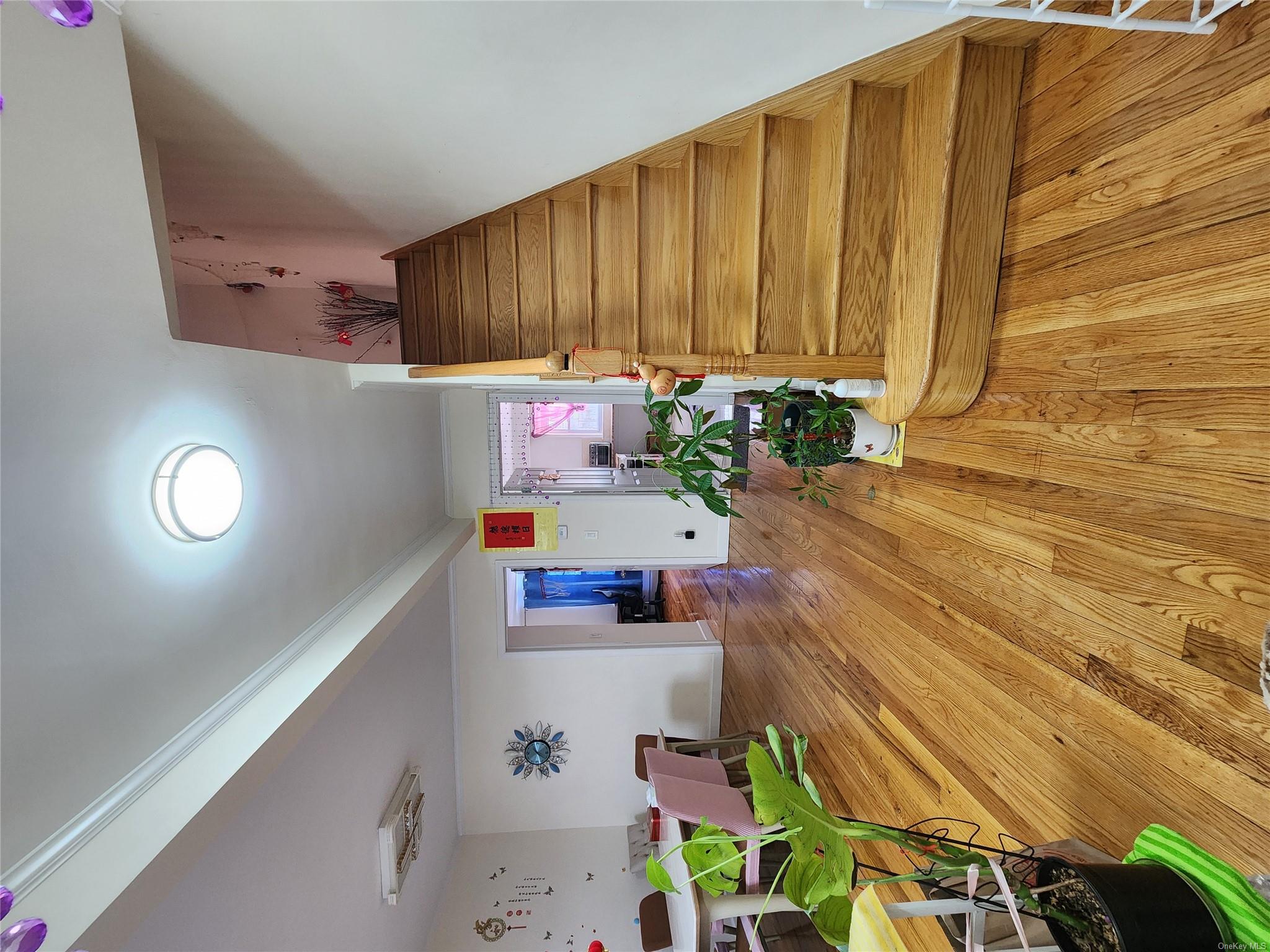 Stairs featuring hardwood / wood-style floors and ornamental molding