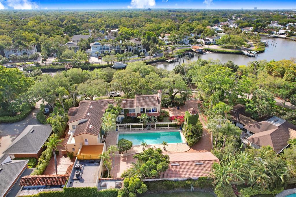 an aerial view of residential houses with outdoor space and lake view