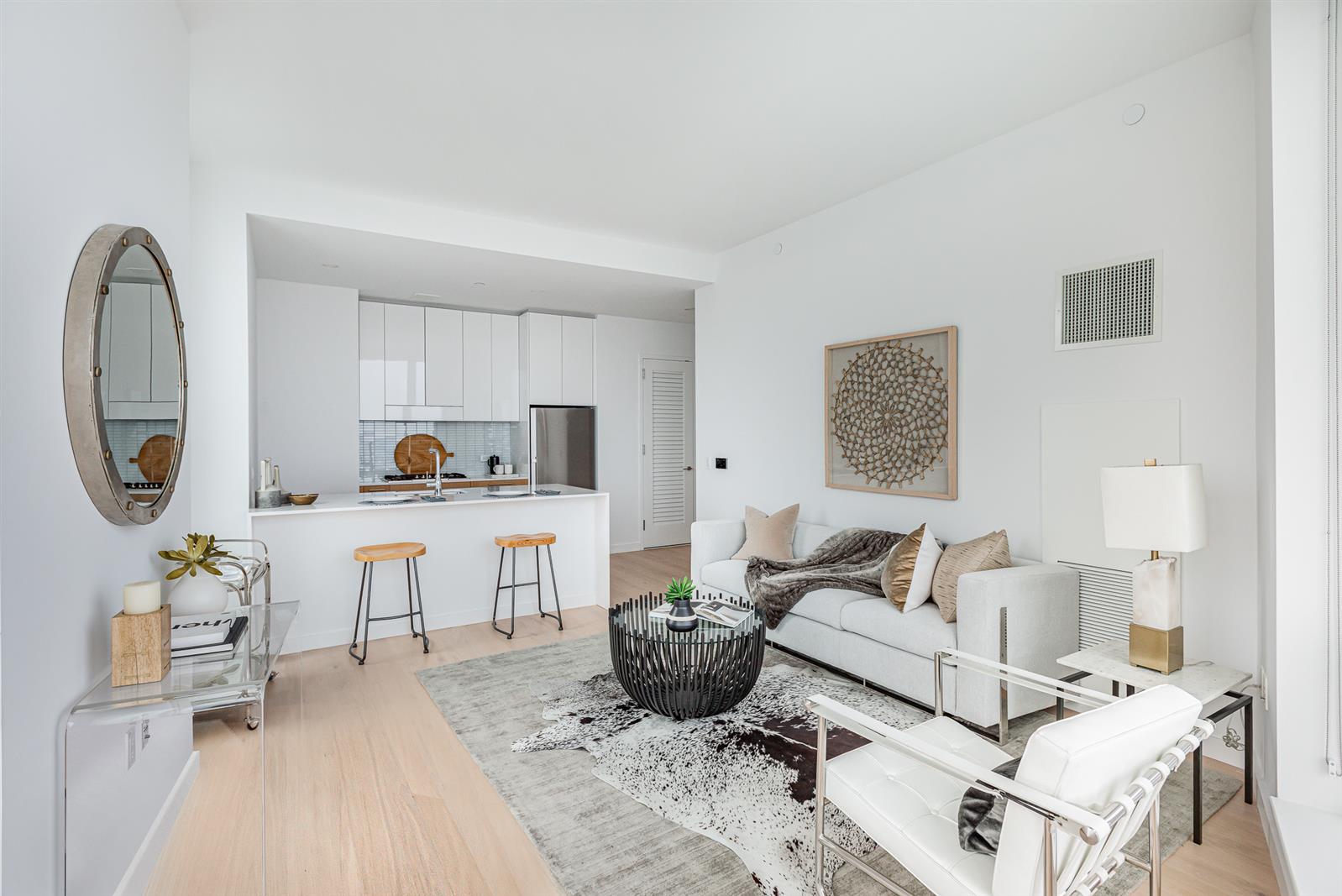 a living room with furniture a rug and white walls