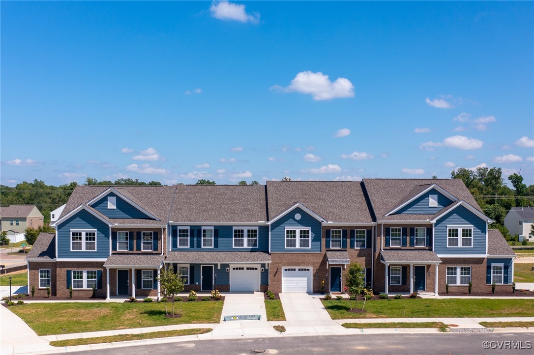 a view of a big house with a big yard and large trees