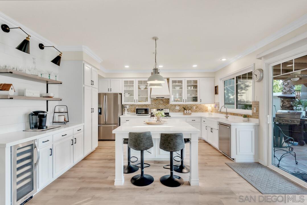 a kitchen with stainless steel appliances kitchen island granite countertop a sink and cabinets