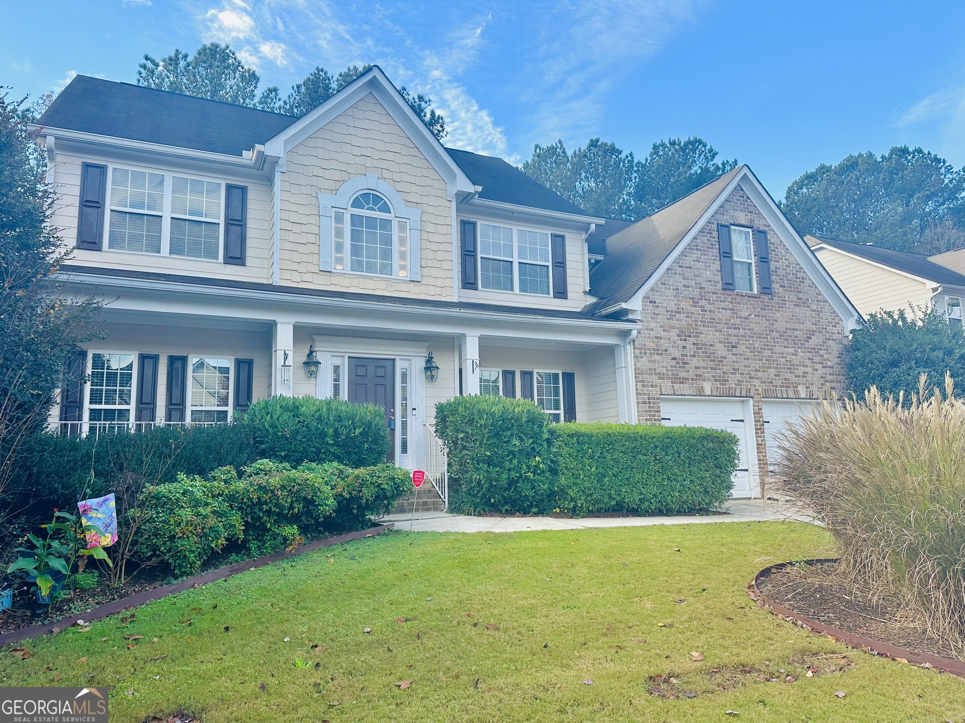 a front view of a house with a yard and garage