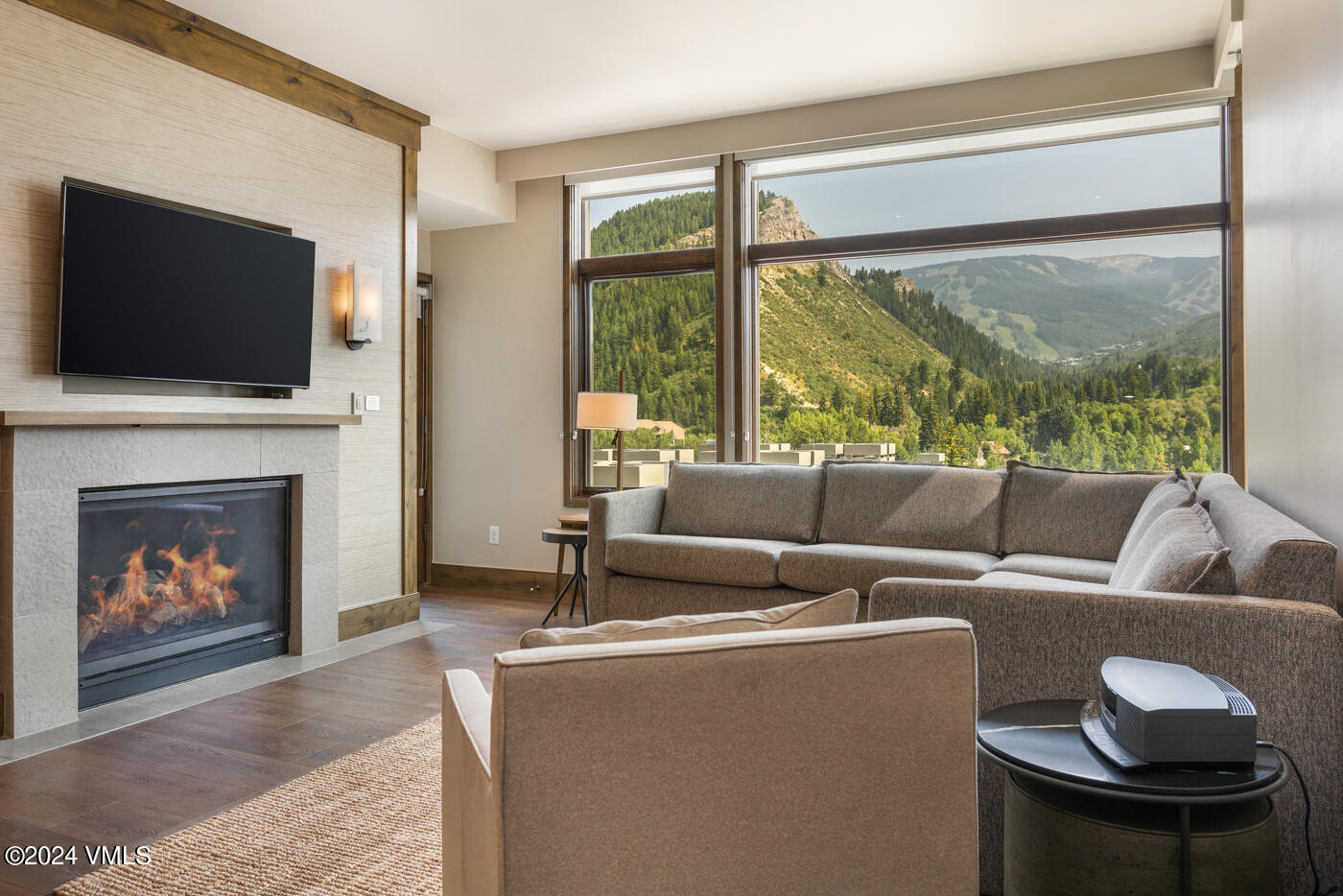 a living room with furniture a fireplace and a flat screen tv