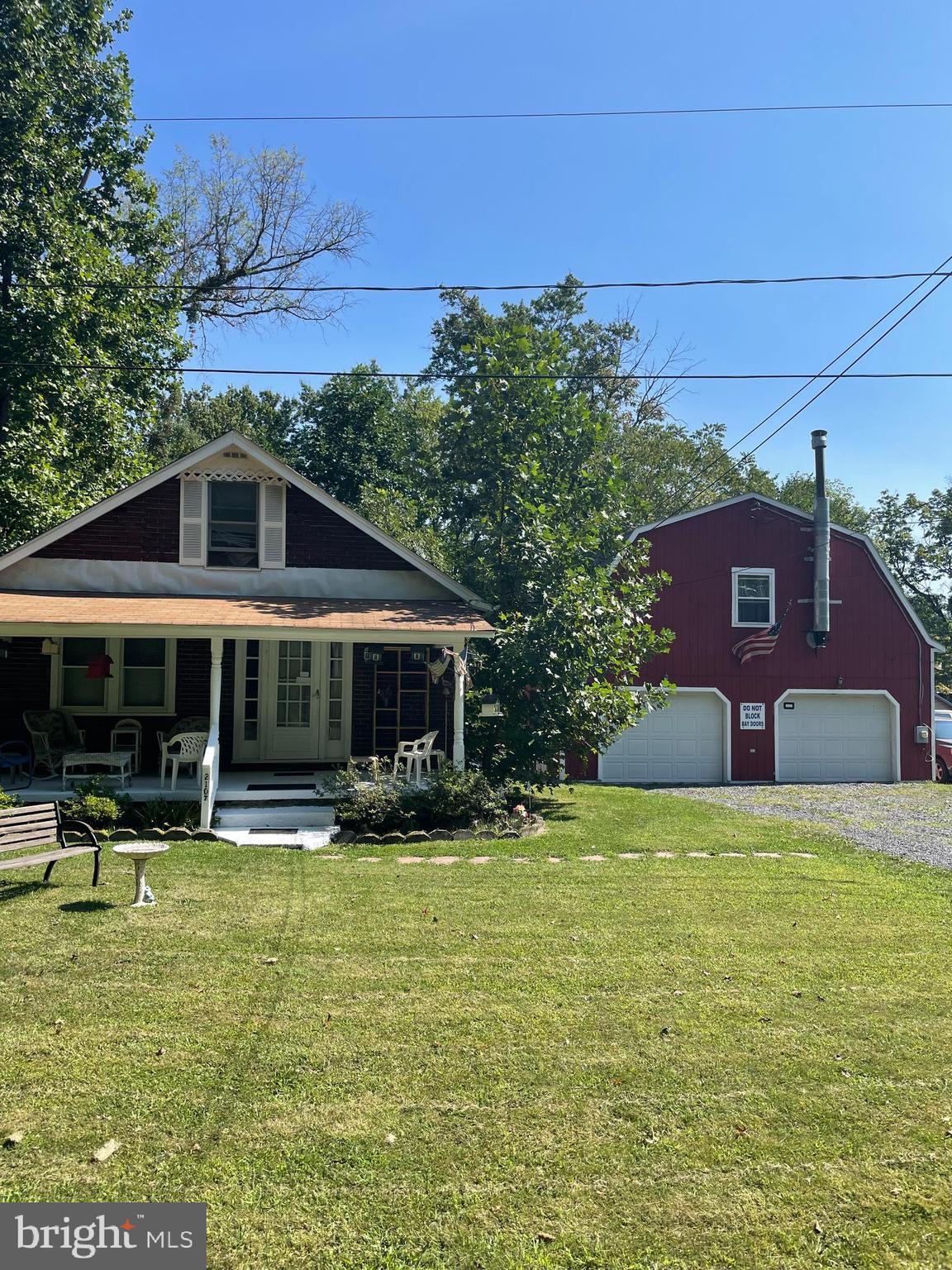 a front view of a house with swimming pool and a yard