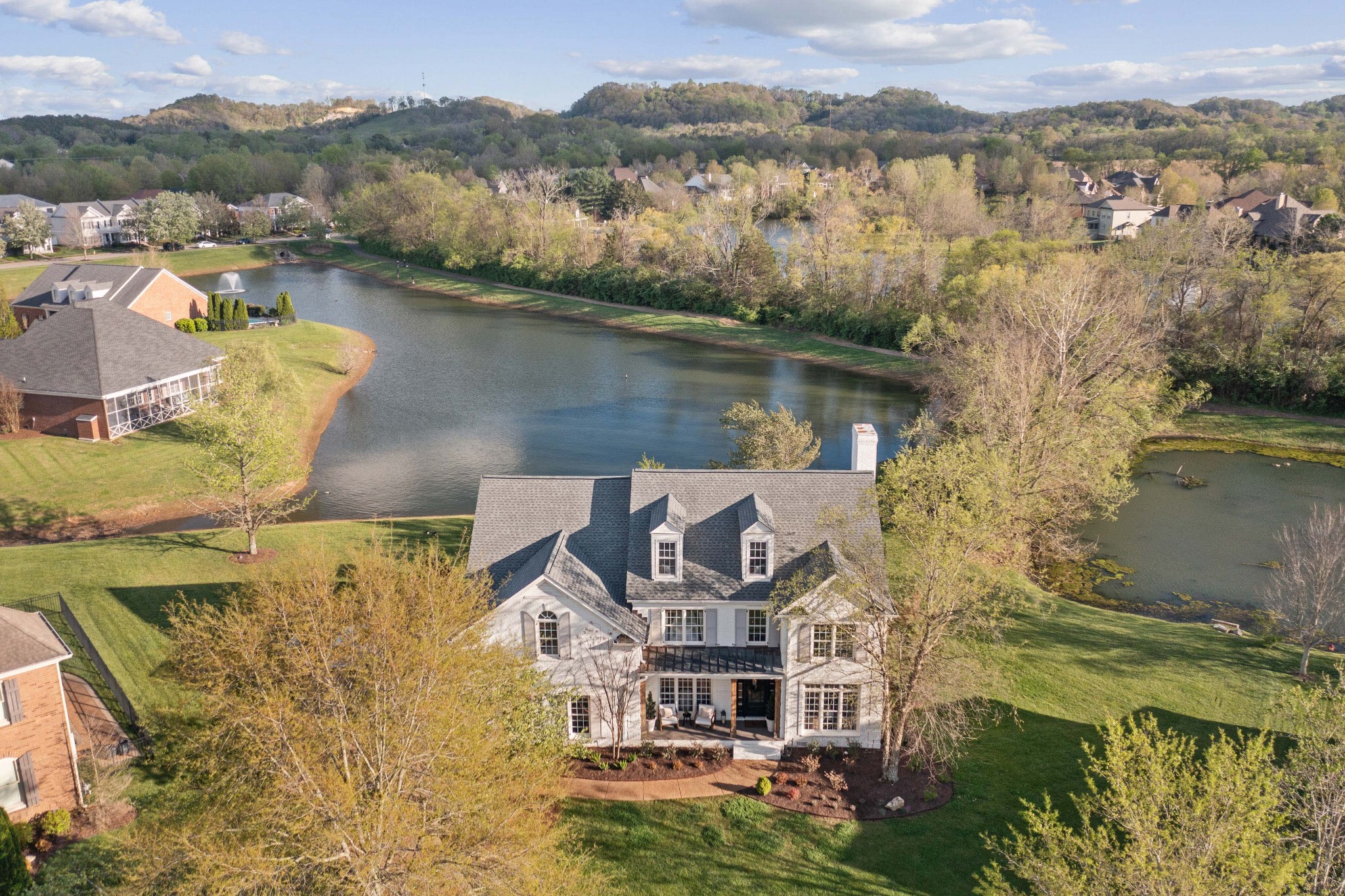 an aerial view of a house with a lake view