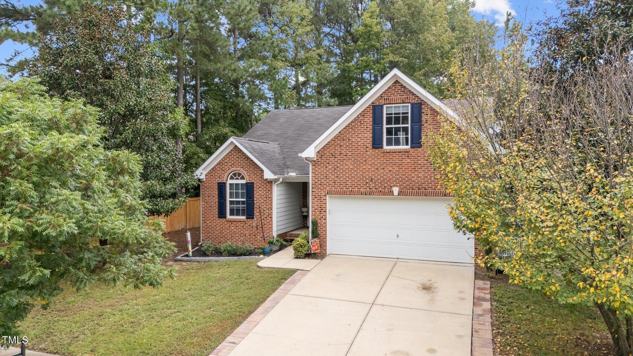 a front view of house with yard and trees