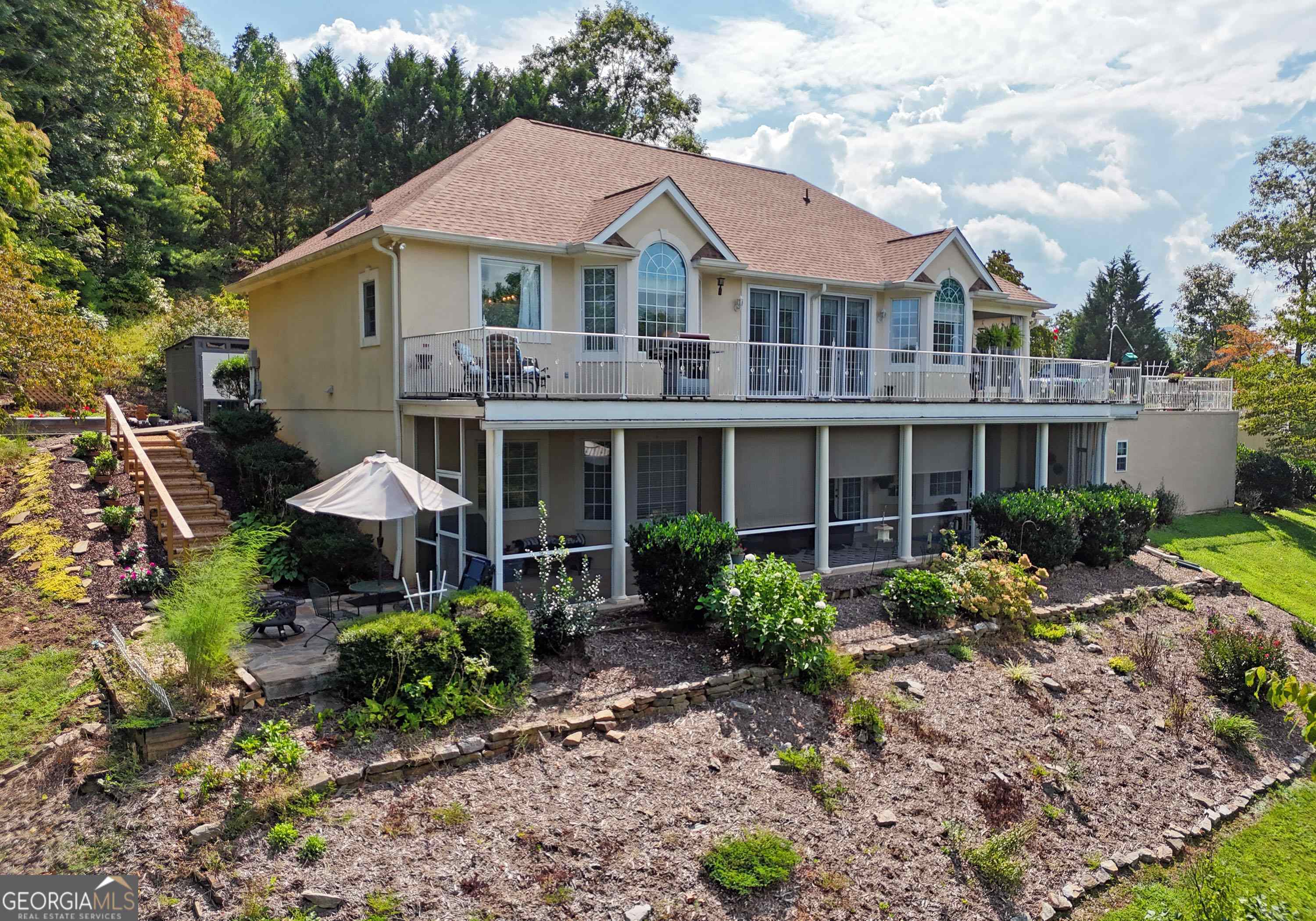 a front view of a house with garden and porch