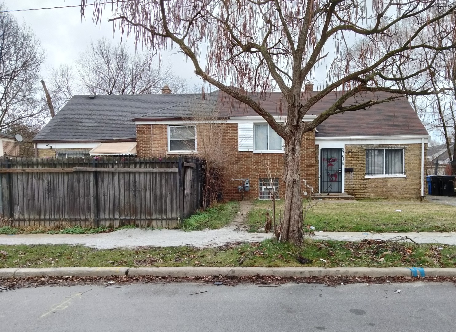 a front view of a house with a garden and trees