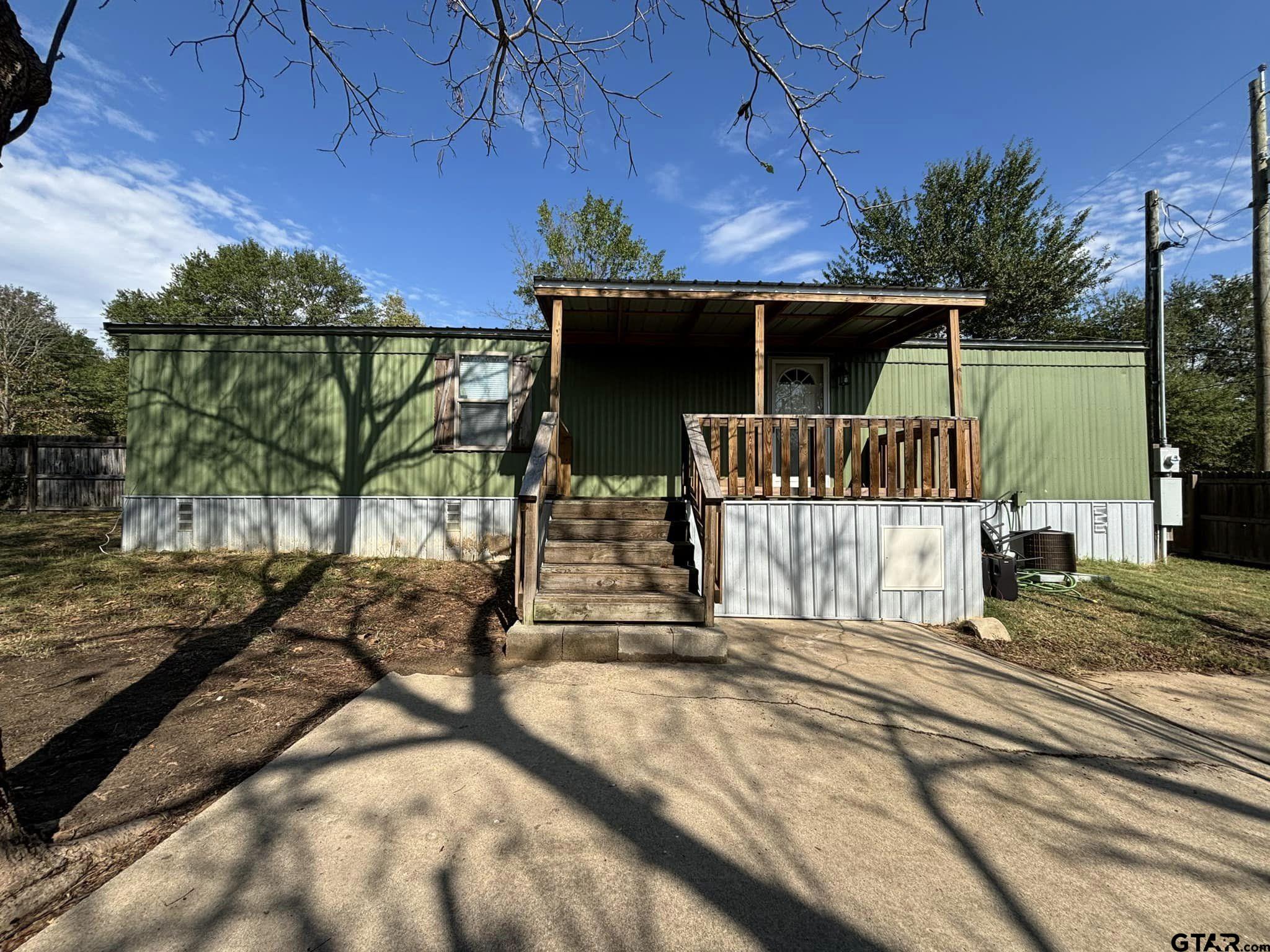 a view of a house with a tree