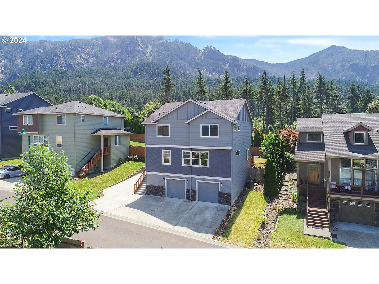 a aerial view of a house with a garden and a yard