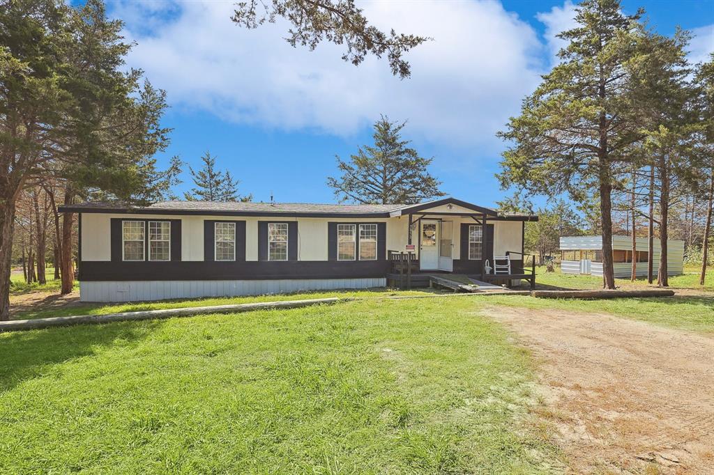 a front view of a house with yard porch and outdoor seating