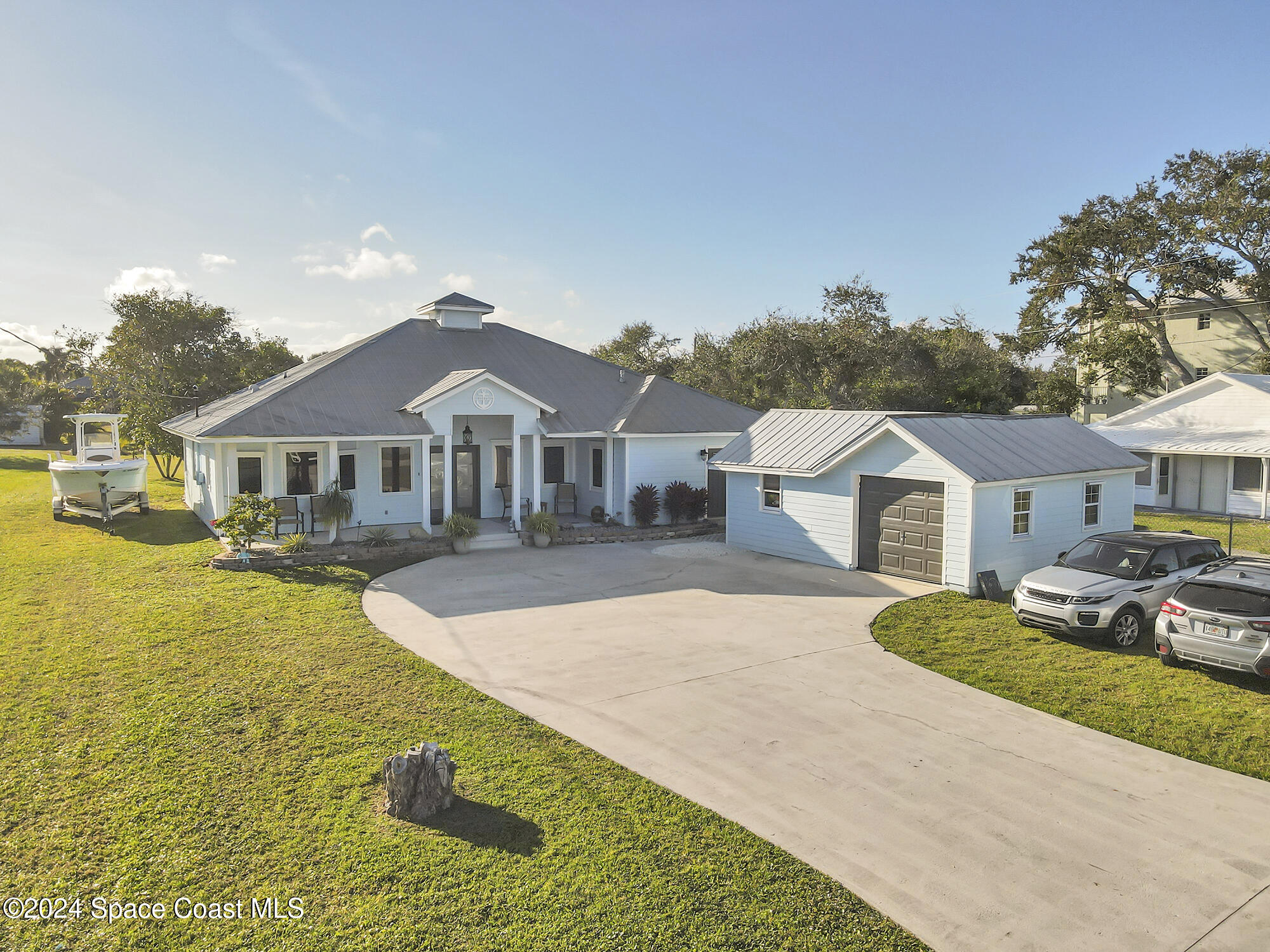 a front view of a house with yard patio and swimming pool