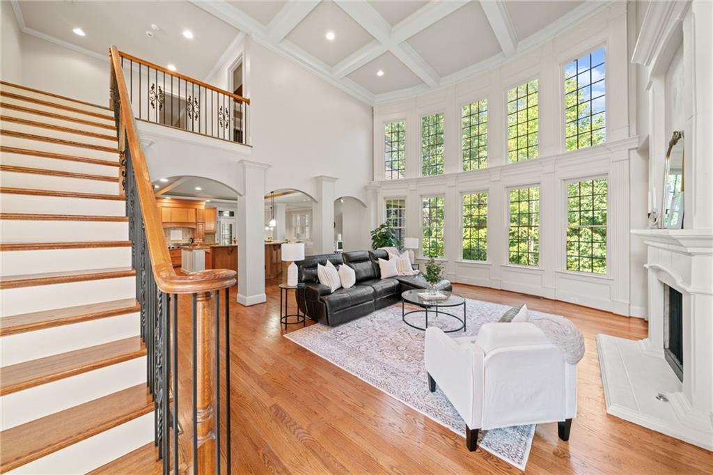 a living room with fireplace furniture and a large window