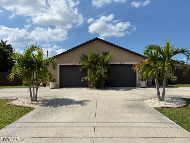 a palm tree sitting in front of a house