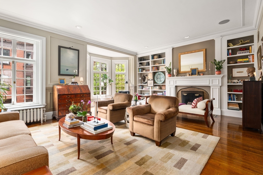 a living room with furniture fireplace and a window