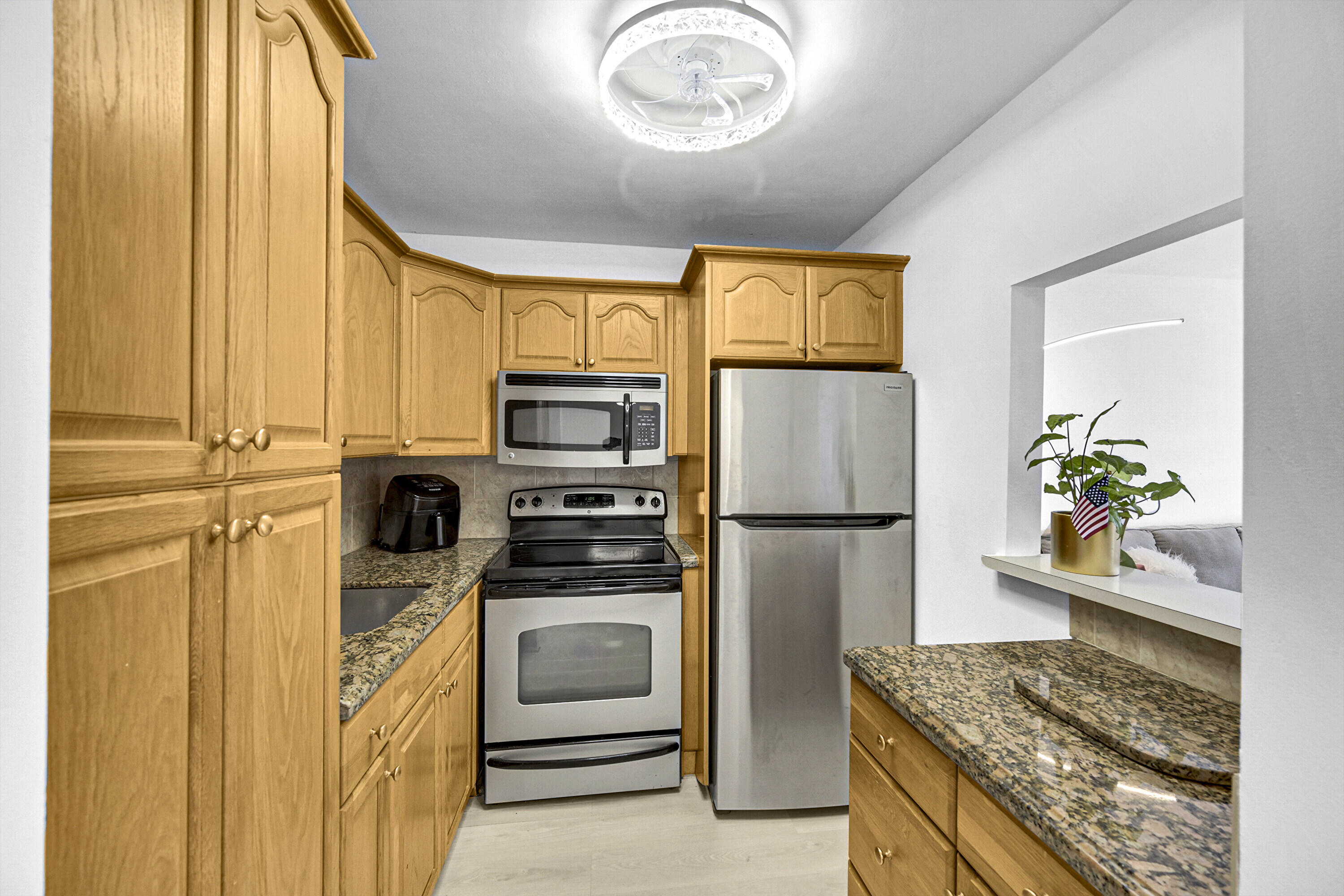 a kitchen with stainless steel appliances a refrigerator a stove a microwave and cabinets