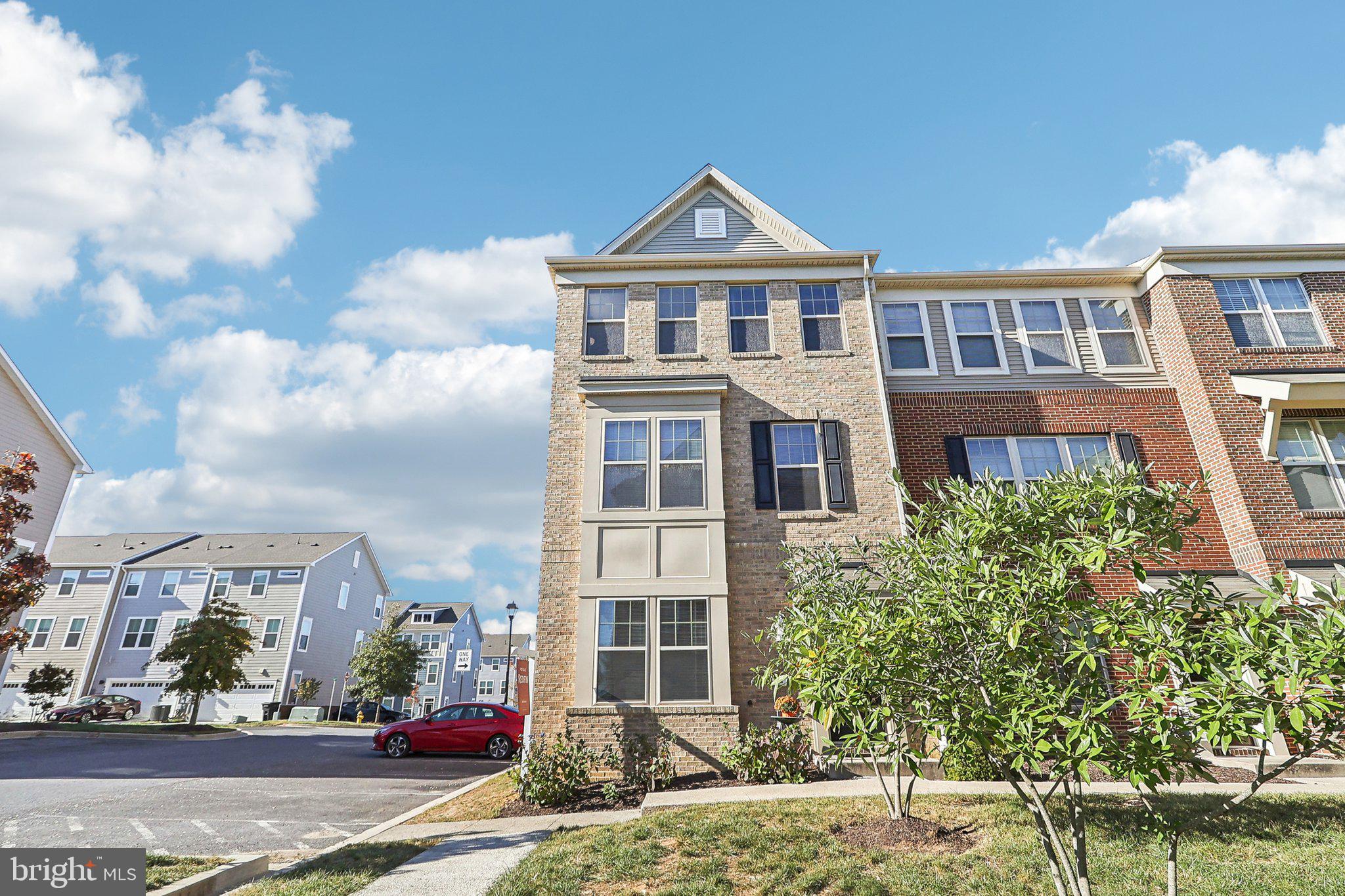 a front view of a residential apartment building with a yard