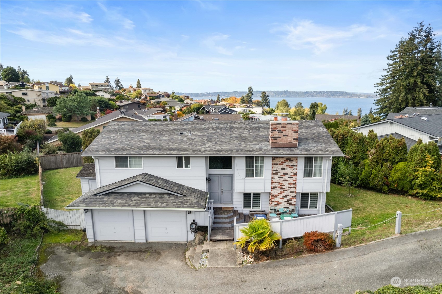 an aerial view of a house with a yard and sitting area