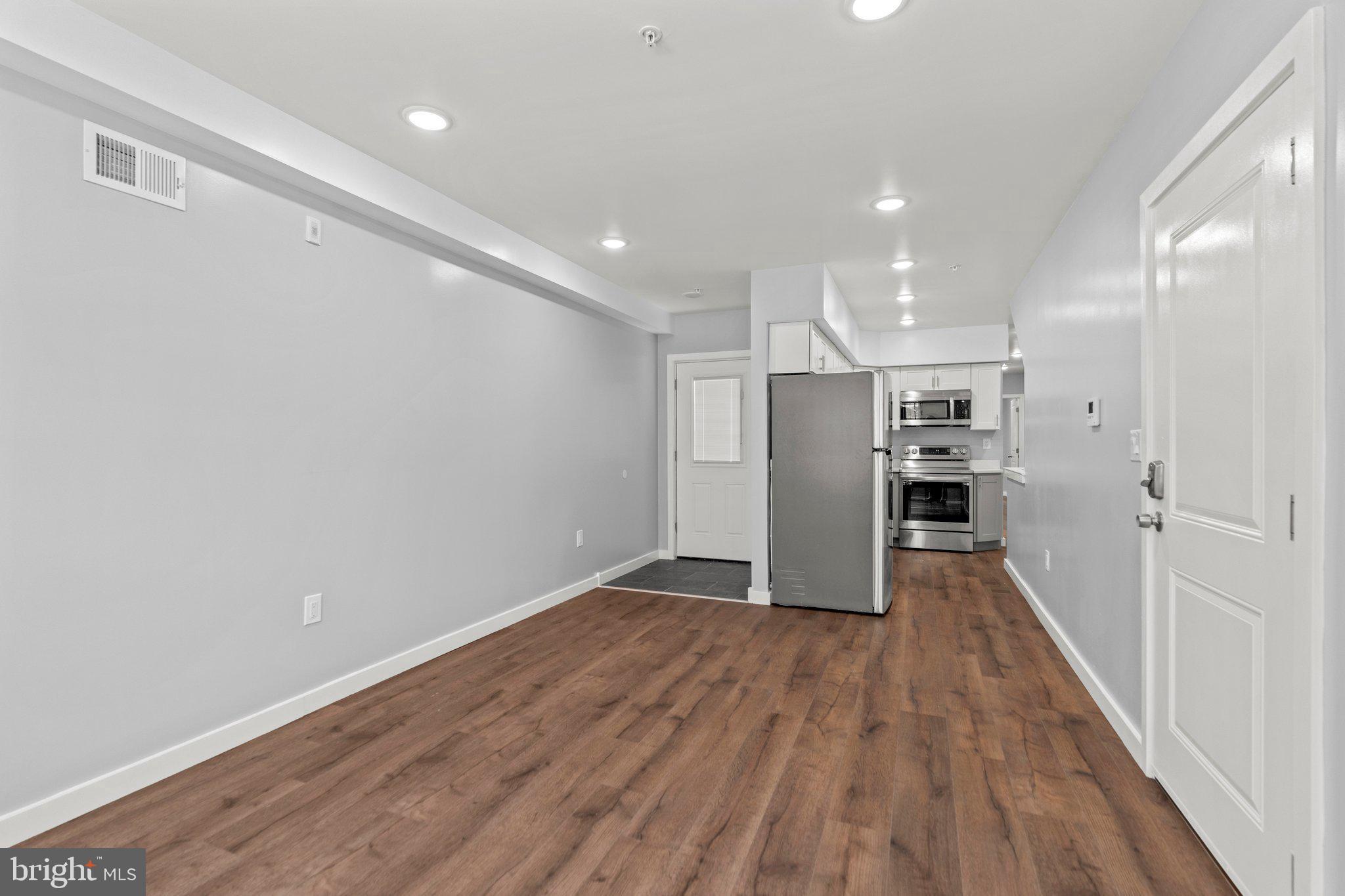 a view of empty room with wooden floor