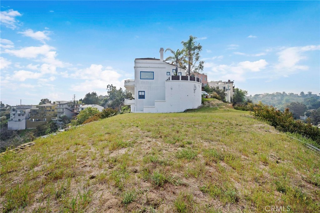 a view of a house with a yard and balcony