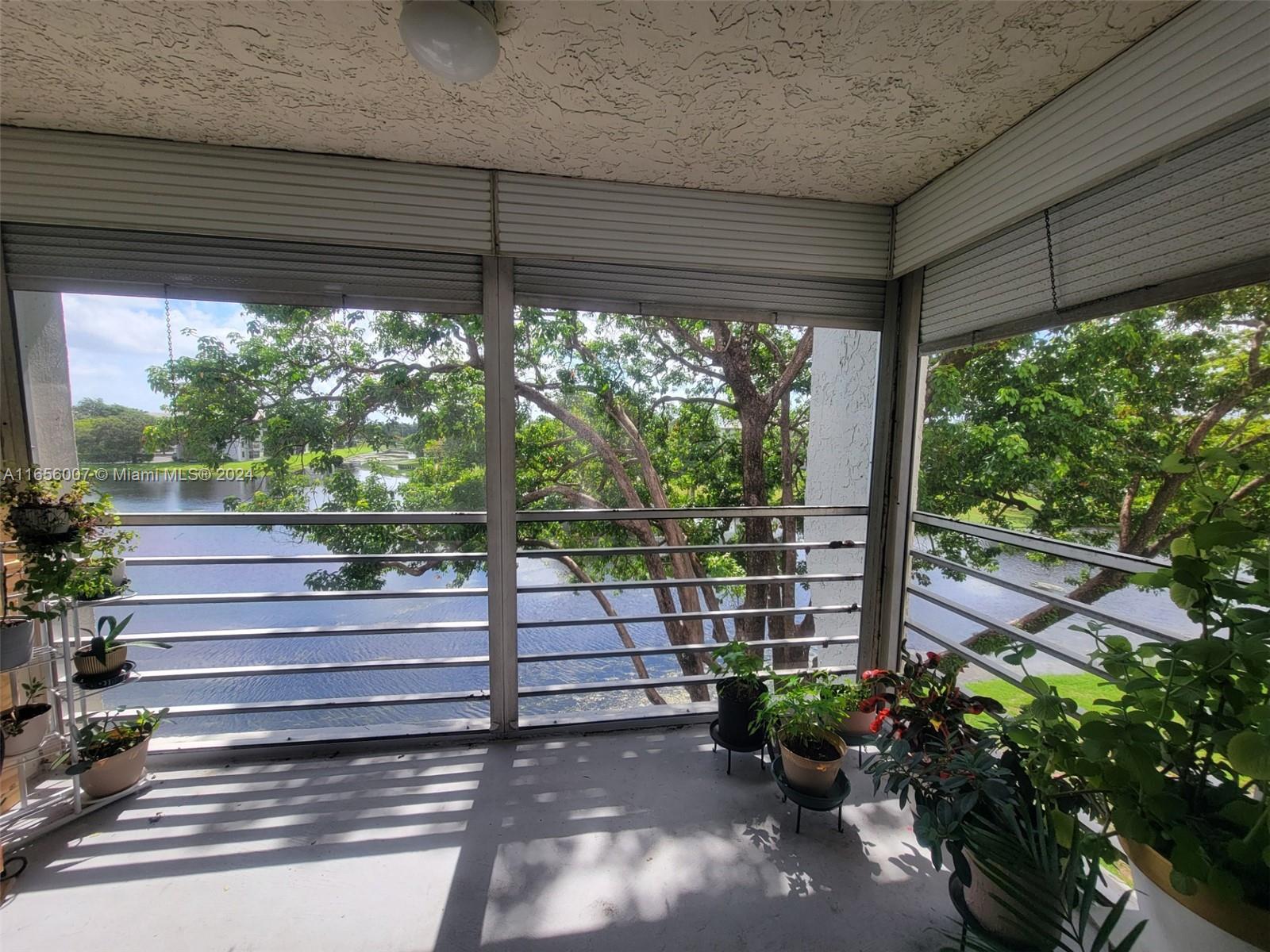 a view of a porch with furniture and garden