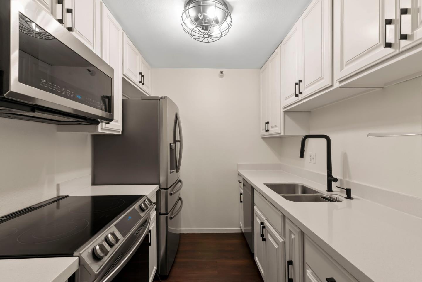 a kitchen with stainless steel appliances granite countertop a sink and a stove