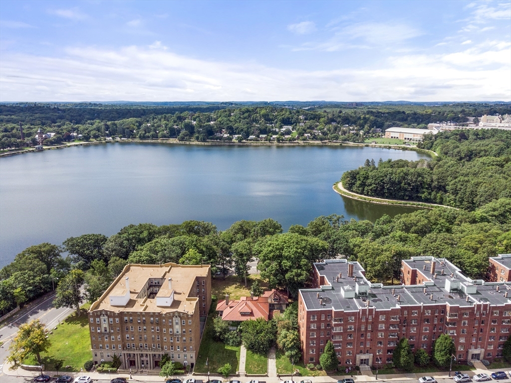 an aerial view of a house with a lake view and mountain view in back