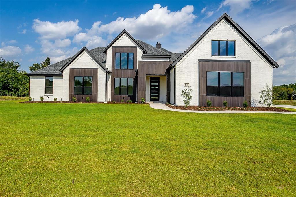 a front view of house with yard and green space