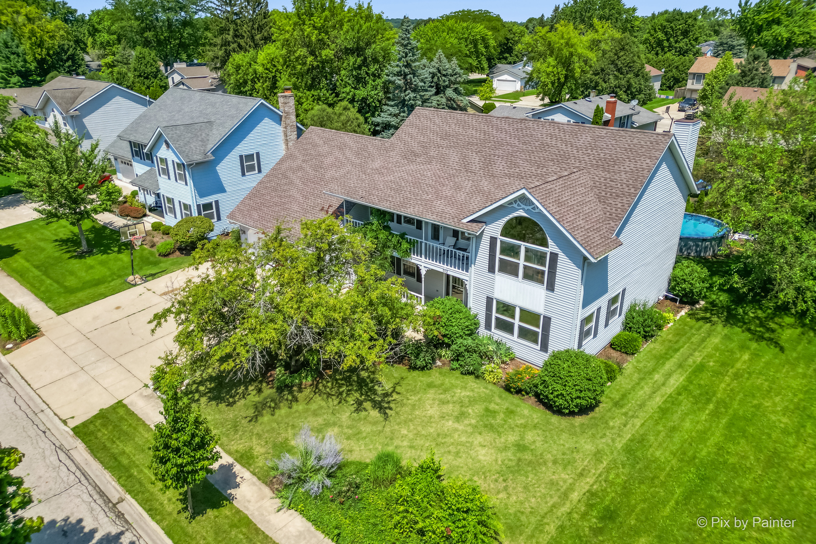 an aerial view of a house with a yard and plants