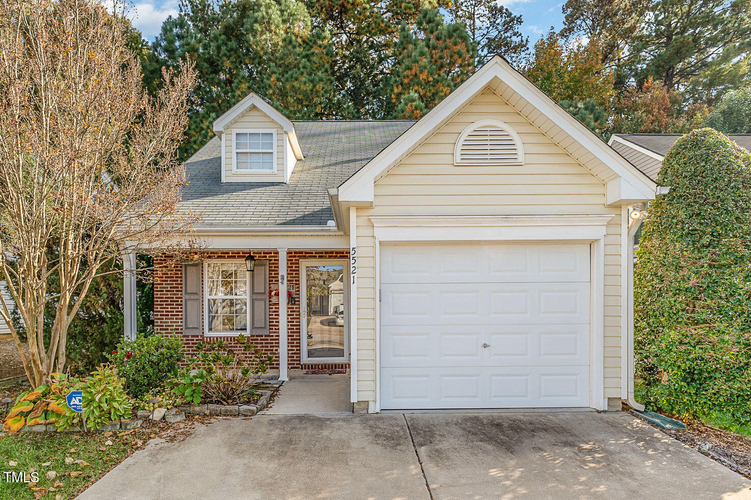 a view of a small house with garage