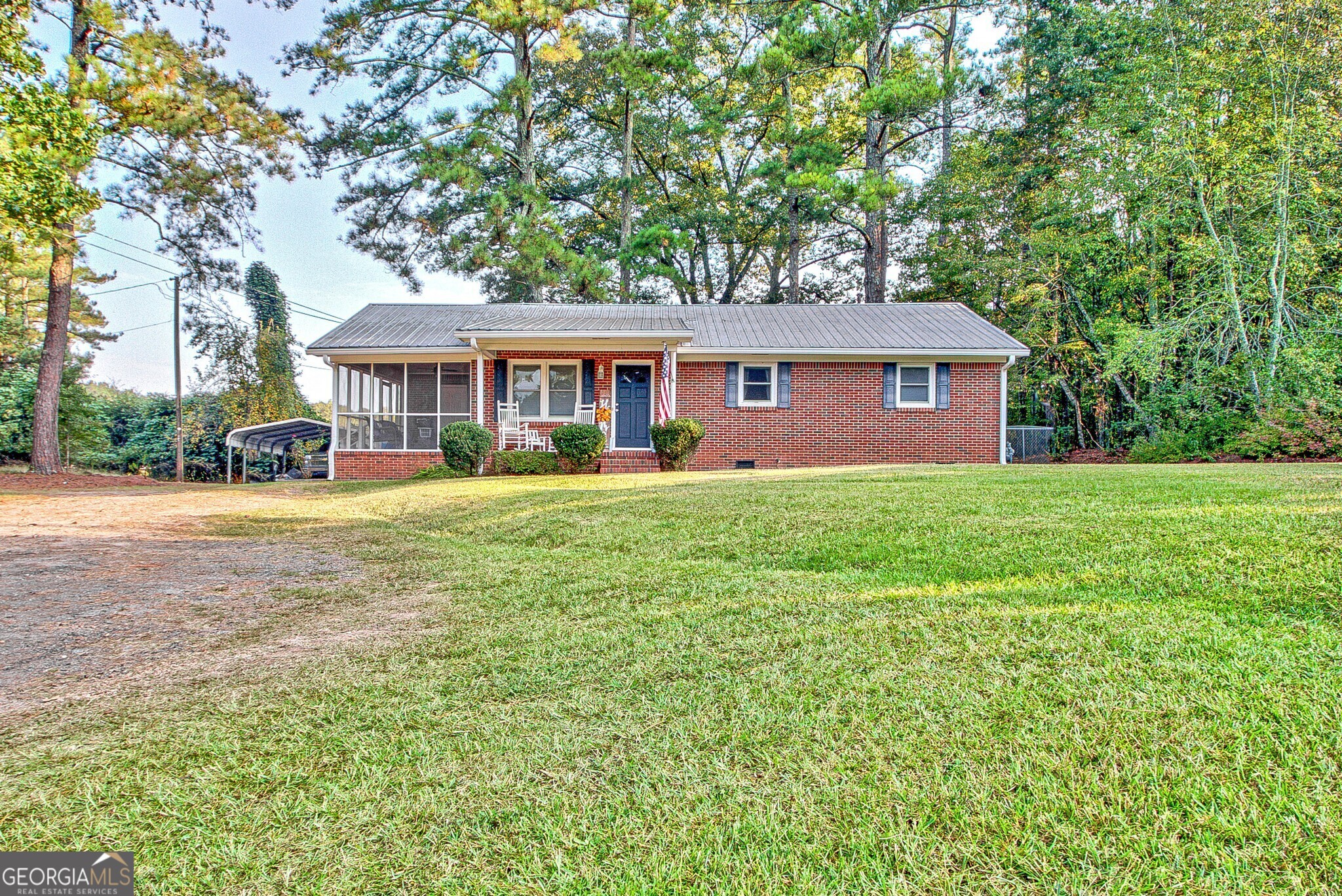 a front view of a house with a yard and trees