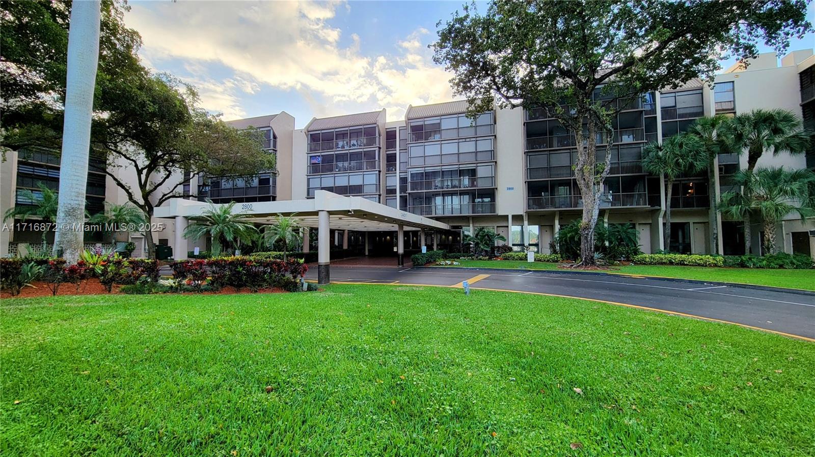 a view of a building with garden and trees