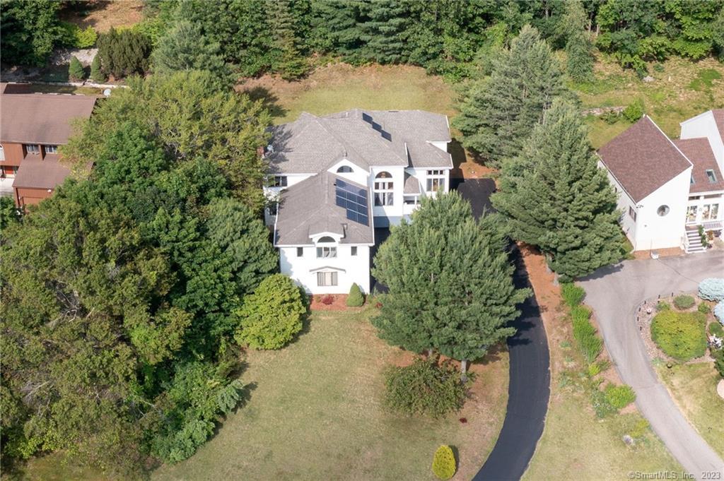 an aerial view of a house with a yard and lake view