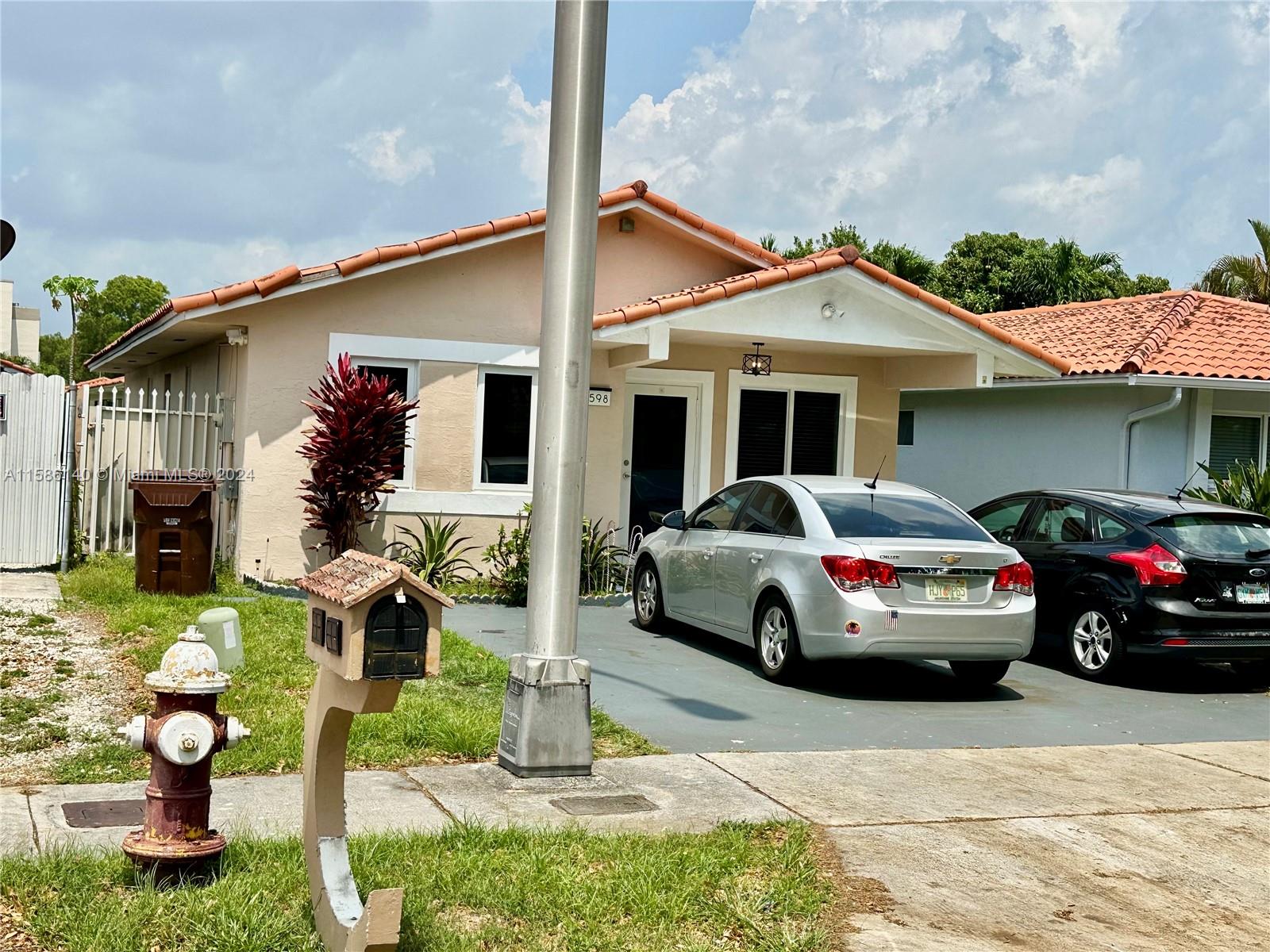 a view of a car parked in front of a house