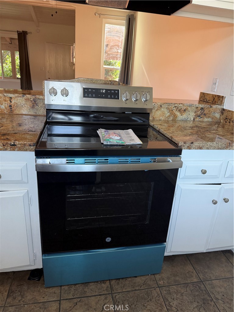 a stove top oven sitting inside of a kitchen