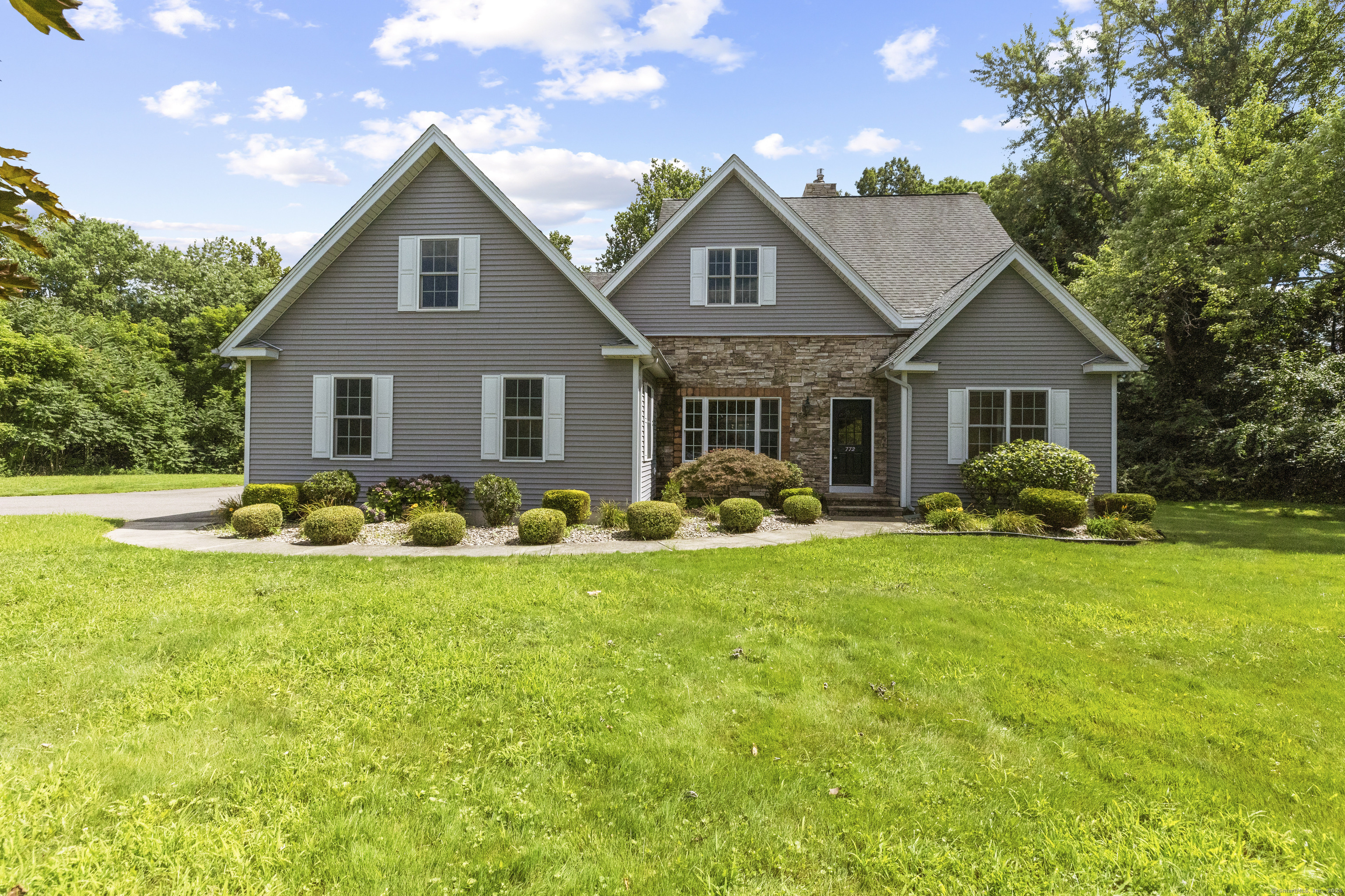 a front view of house with yard and green space