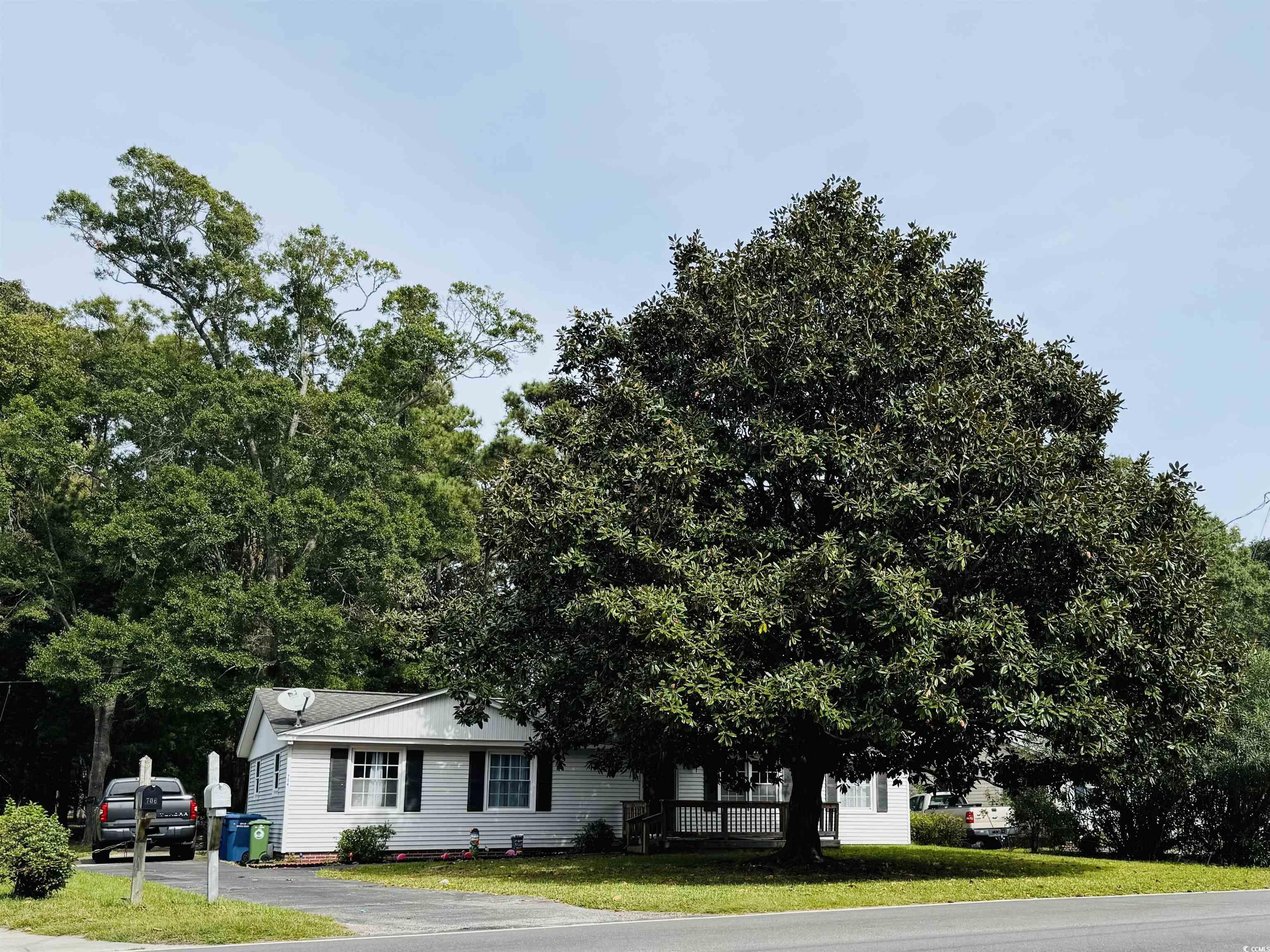 View of the front of the property, featuring matur