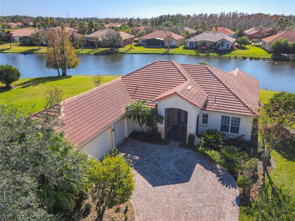 an aerial view of house with yard and lake view